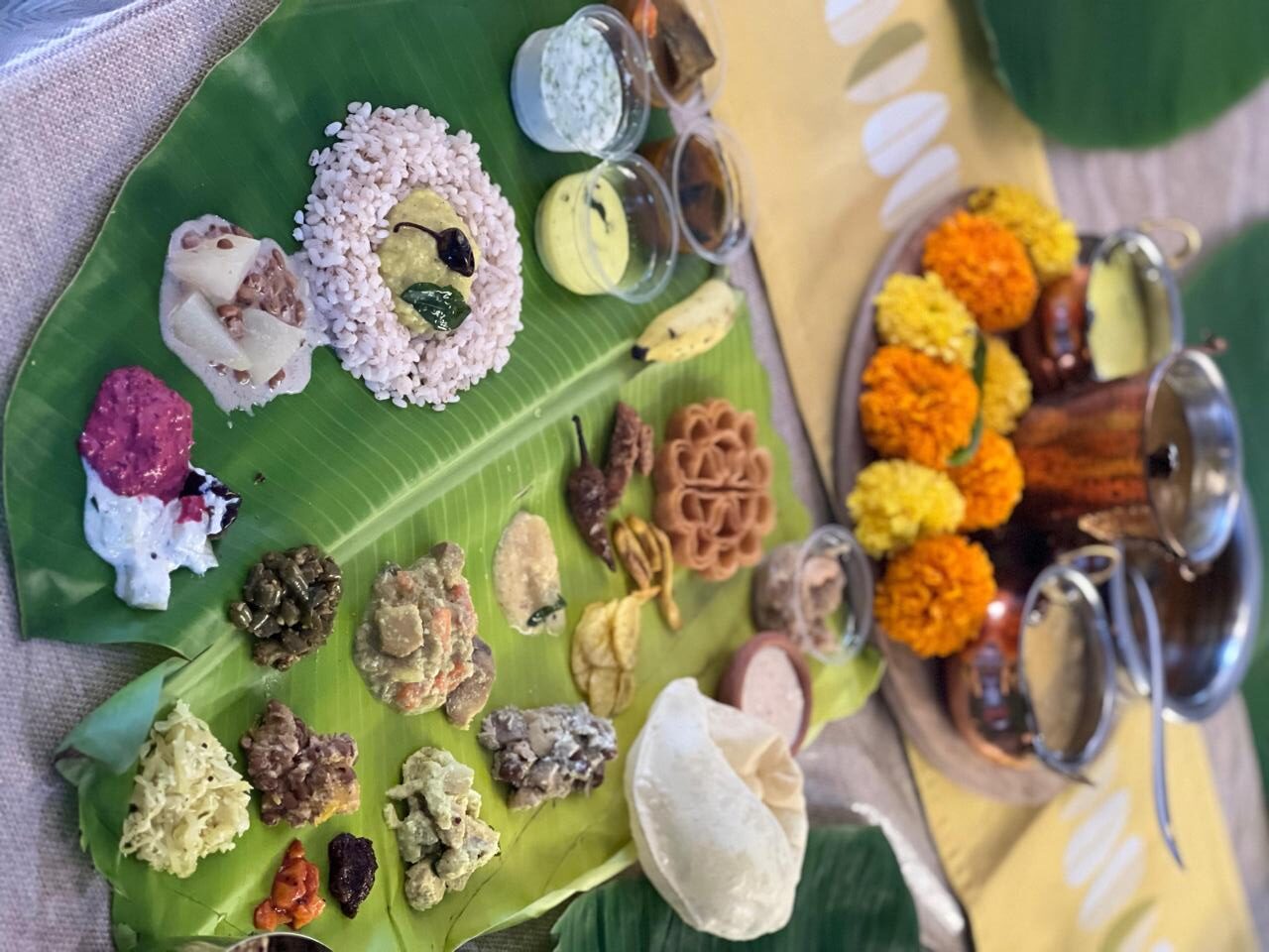 Chef Meera Girija Tadimeti’s Onam Sadhya 2025 curated festive feast with traditional Kerala dishes served on banana leaf, covered by Fridaywall Magazine